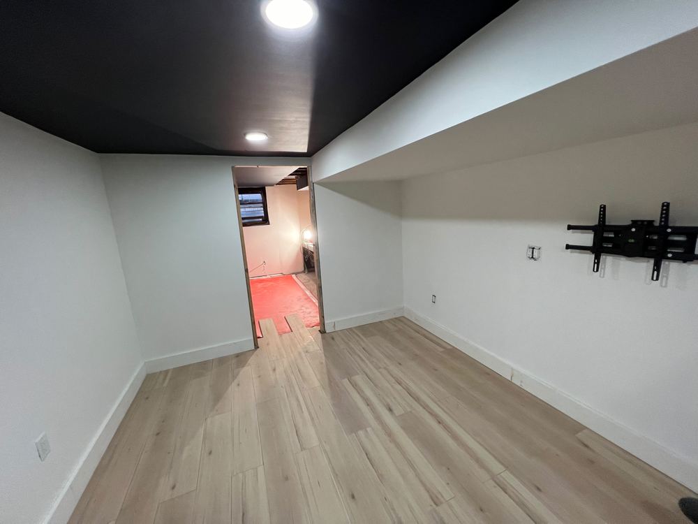 Basement with Black Ceiling and Grey Bath